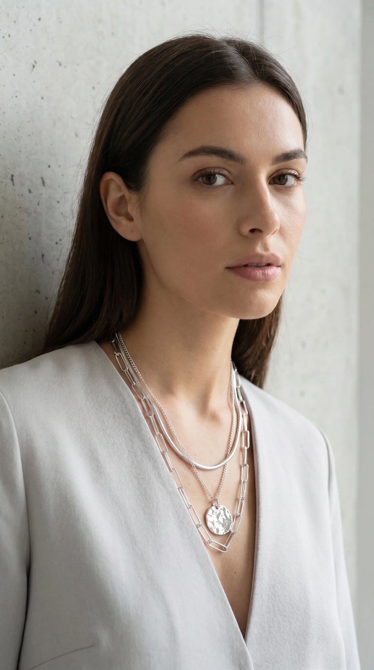 Envy Short silver triple layered necklace with a battered circle pendant