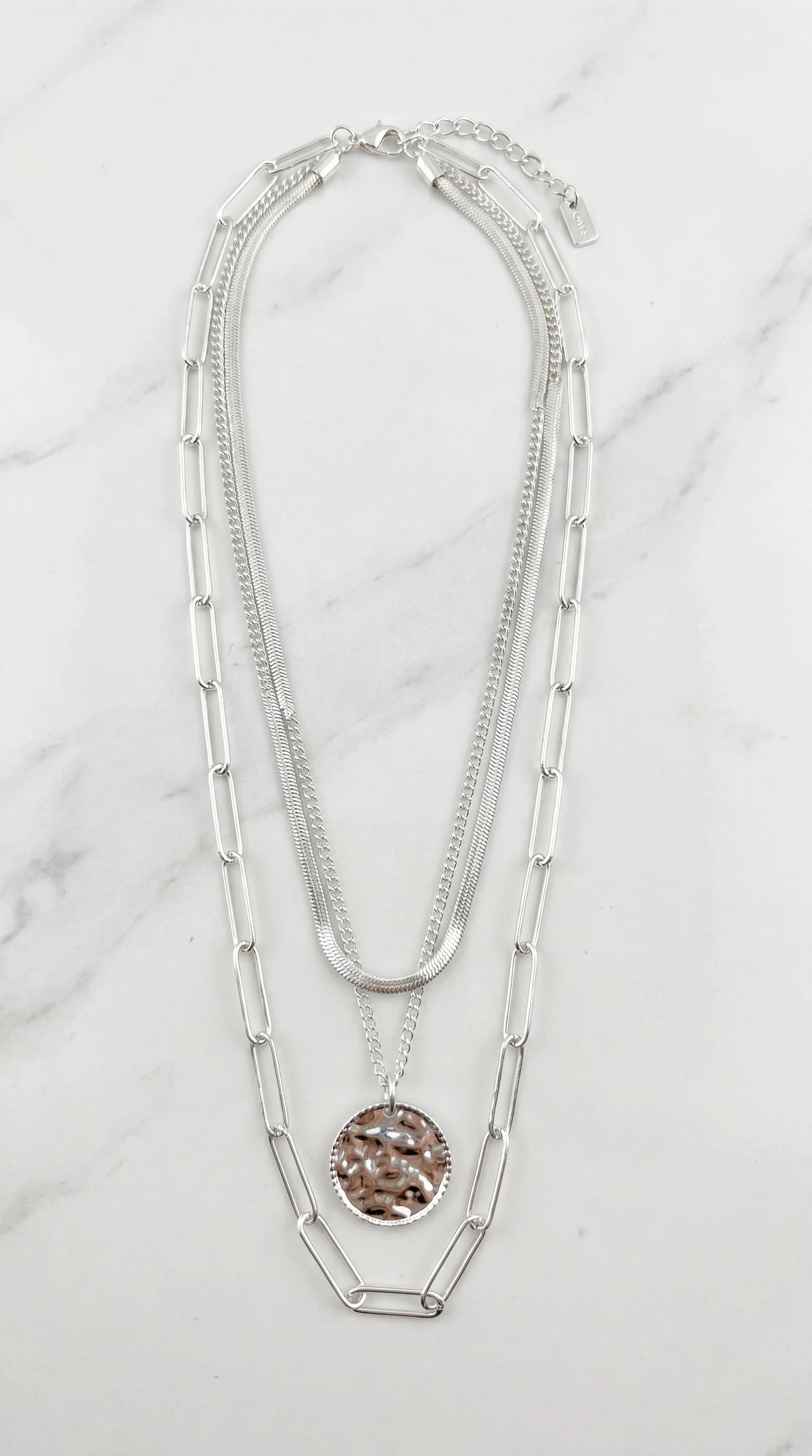 Envy Short silver triple layered necklace with a battered circle pendant
