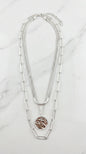 Envy Short silver triple layered necklace with a battered circle pendant