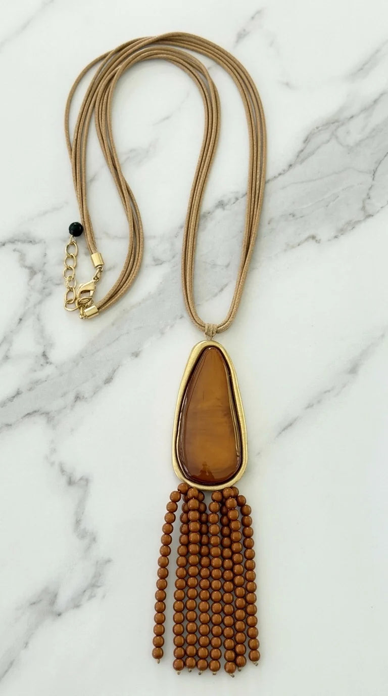 Long multi cord necklace with large brown resin and tassel pendent