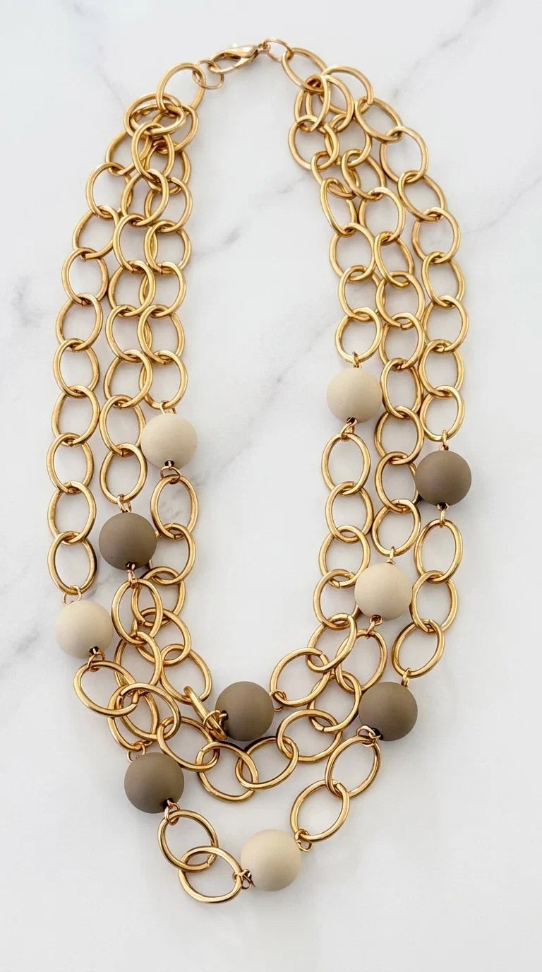 Envy Short triple gold link necklace with taupe and cream resin ball detail