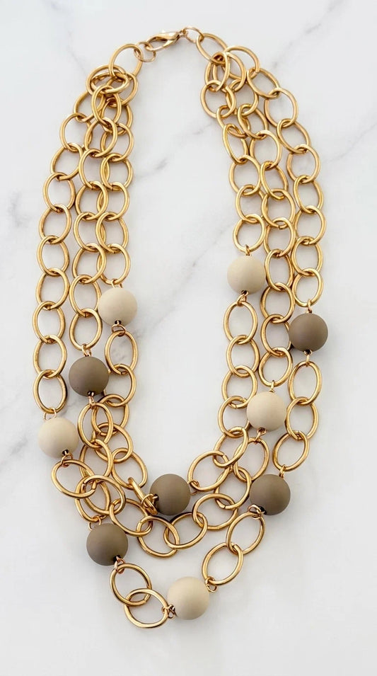 Envy Short triple gold link necklace with taupe and cream resin ball detail