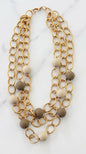 Envy Short triple gold link necklace with taupe and cream resin ball detail