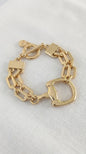 Envy Gold double layered linked chain bracelet with horsebit design