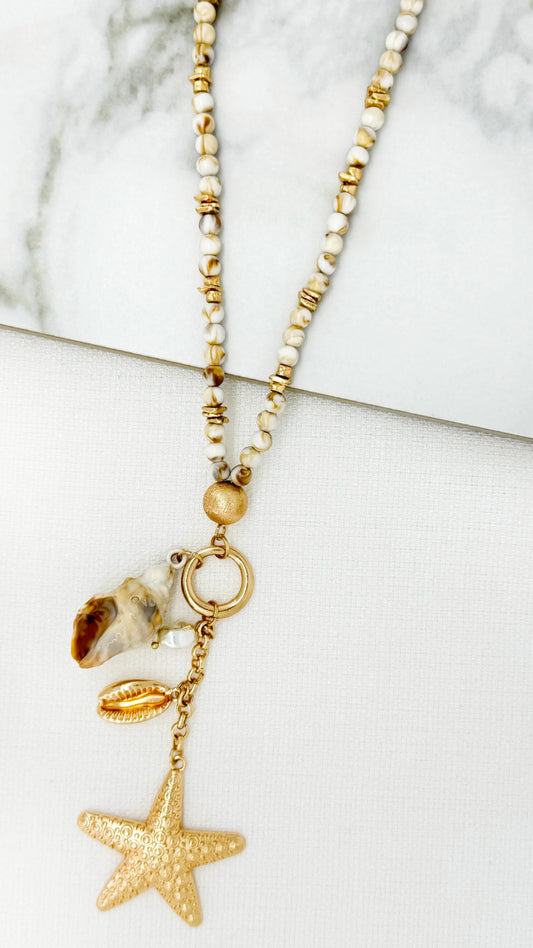 Envy Long gold and bead necklace with starfish and shell pendants